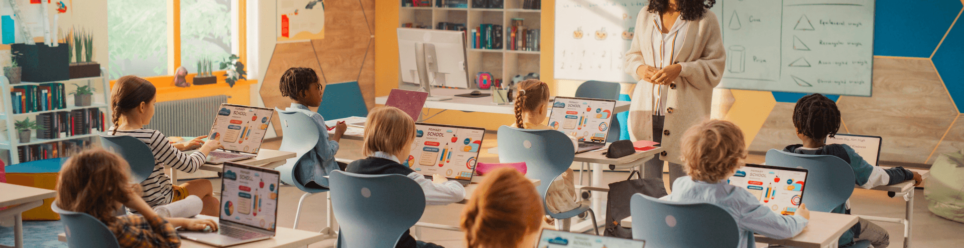 Classroom and school teacher teaching while kids use technology